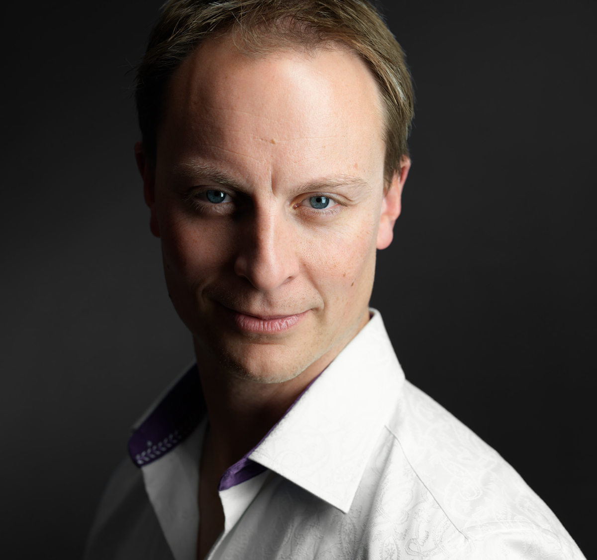 Professional headshot of a male actor wearing a white dress shirt taken at NYC Headshot